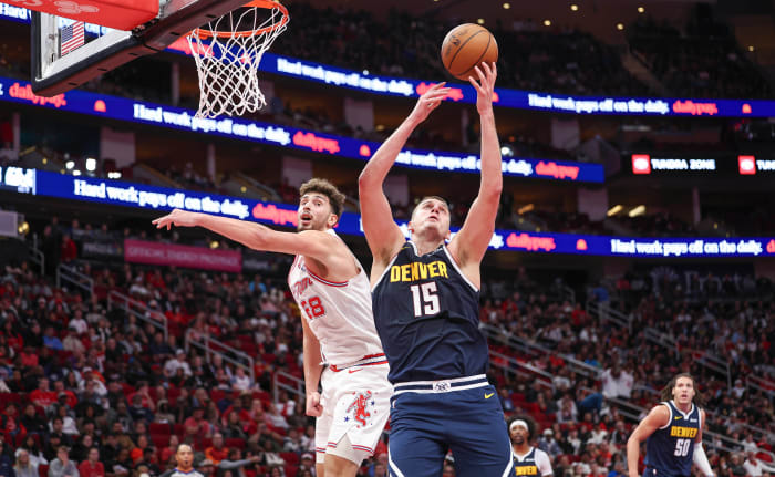 Denver Nuggets center Nikola Jokic grabs a rebound away from Houston Rockets center Alperen Sengun